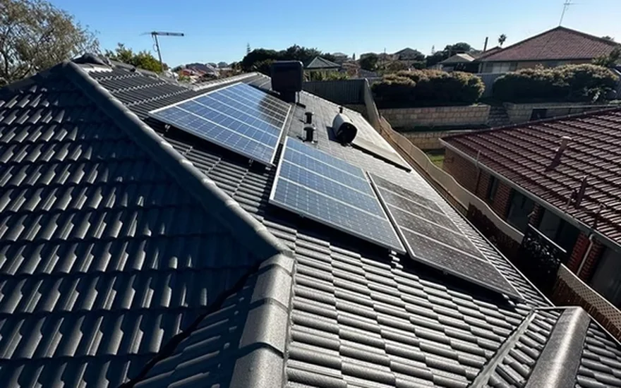 Tile roof with clean solar panels after a gutter and solar panel service