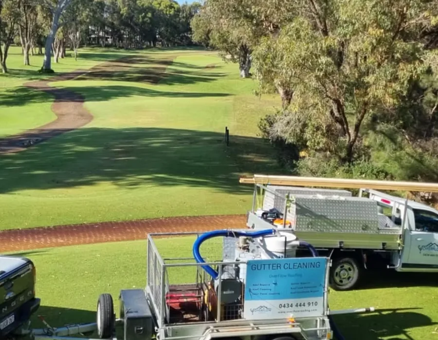 Overflow Group branded gutter cleaning trailer set up on a golf course fairway