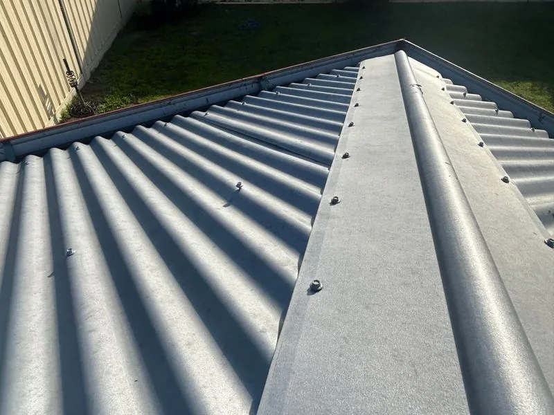 Clean metal roof ridge after maintenance