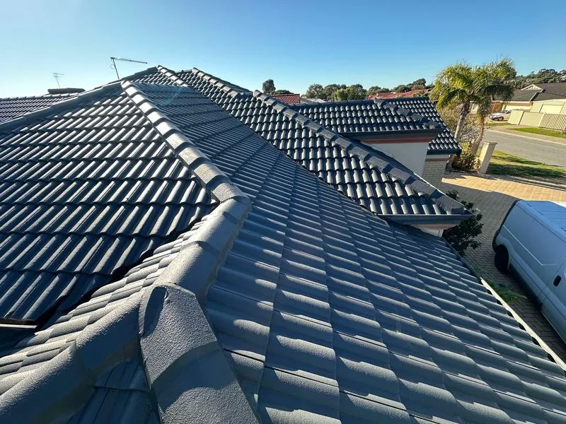 Newly repointed ridge capping on a grey tile roof